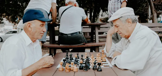 two men playing chess by Vlad Sargu courtesy of Unsplash.
